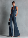 FJØRNA women's dark denim flared jumpsuit with high neck, sleeveless design, and front zipper, styled as pants.