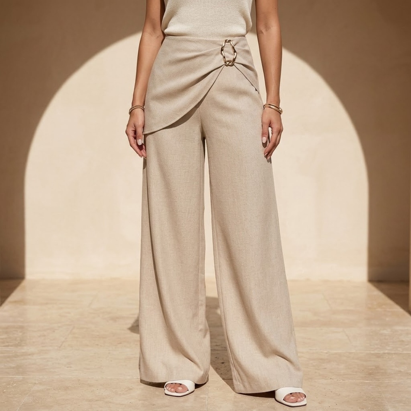 Women’s beige asymmetric waist trousers with metal buckle from FJØRNA, featuring stylish design and comfortable fit.