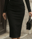FJØRNA off-shoulder draped midi dress for women with sculpted waist, showcasing elegant fabric and stylish design.
