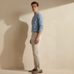 FJØRNA men's straight leg trousers, stylish pants with a tailored fit, shown in a neutral color on a model.