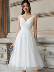 FJØRNA sleeveless v-neck pleated midi dress with cap sleeves, elegant and flowing design, shown on model.