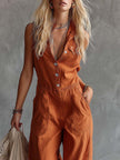 Rust orange cotton western V-neck sleeveless jumpsuit by FJØRNA, featuring a fitted waist and wide-leg design.