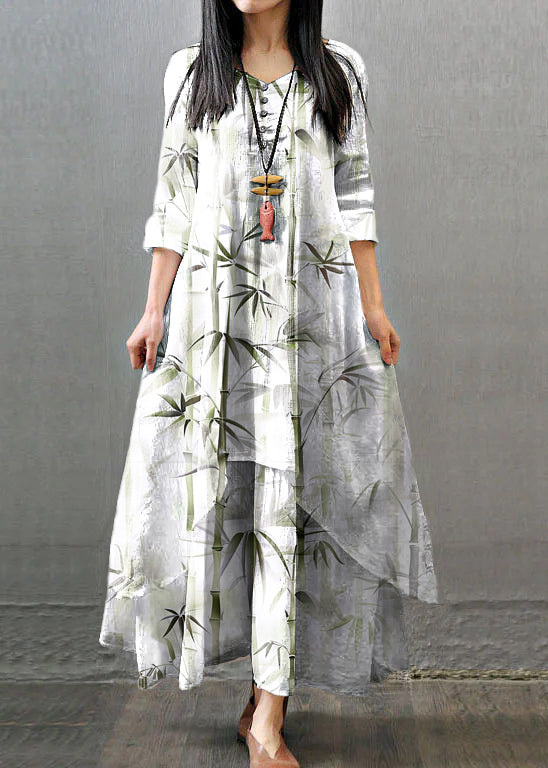 White FJØRNA long sleeve vintage maxi dress with double layers, button details, and asymmetric design, perfect for elegant occasions.