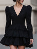 FJØRNA black leather mini dress with puff sleeves and tiered design, stylish and dramatic for evening wear or special occasions.