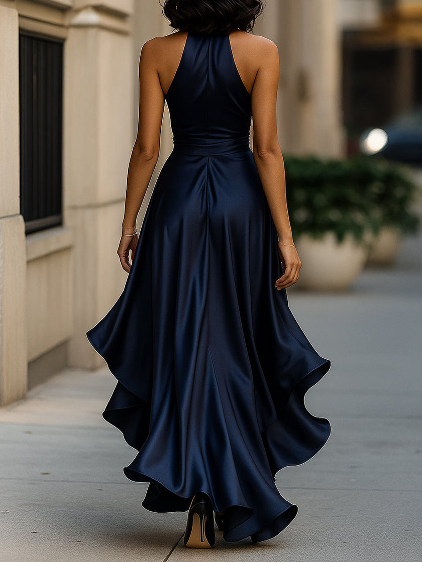 FJØRNA Midnight Elegance satin halter ruffle gown displayed on a hanger with flowing fabric and ruffle details.