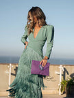 FJØRNA elegant women's V-neck dress with fringe details, stylish and flowing for sophisticated occasions.