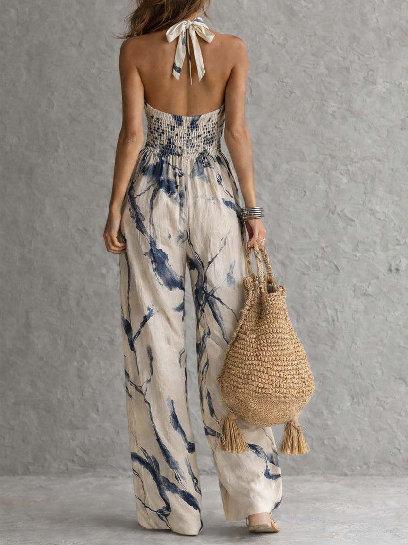 White ink wash print sleeveless jumpsuit with halter neck, wide-leg design, and pockets by FJØRNA.