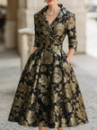 FJØRNA black and gold jacquard floral midi dress with intricate pattern and elegant fit, perfect for formal occasions.