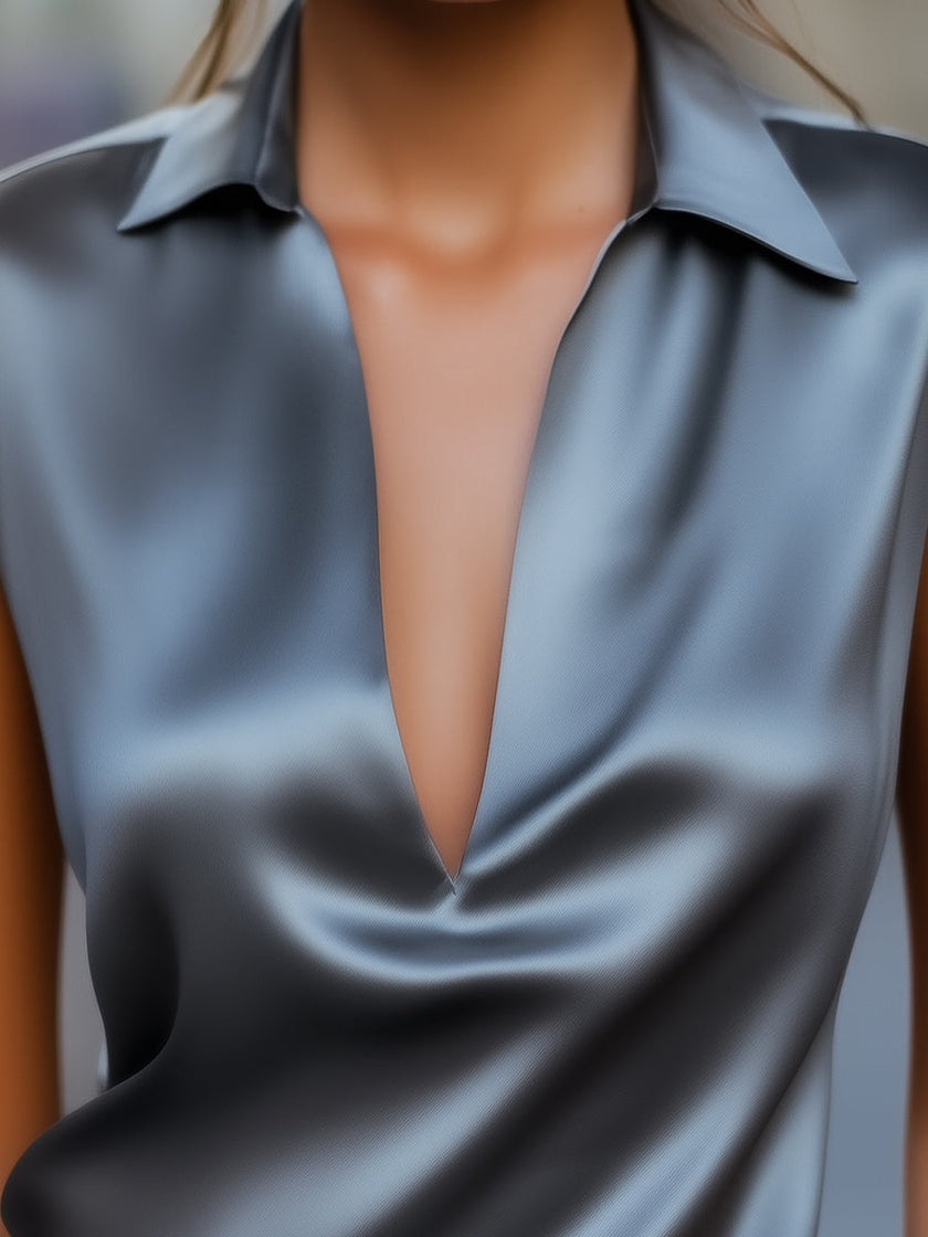 Gray satin plunge neck top for women by FJØRNA, featuring a sleek design and smooth fabric.