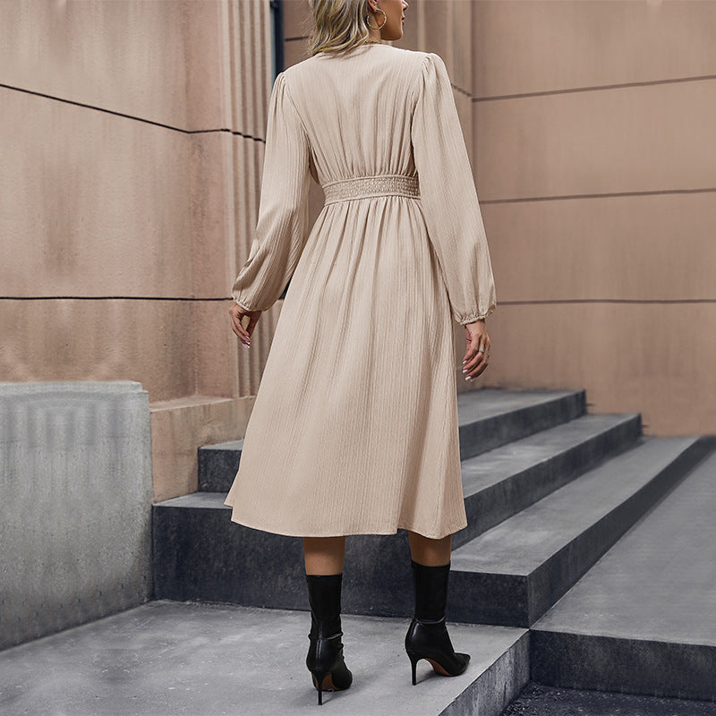 FJØRNA Spring Chic white dress displayed on a hanger, featuring a flowy fabric and elegant design for spring fashion.