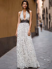 FJØRNA elegant polka dot halter maxi dress with black lace waist inlay, flowing fabric and stylish design perfect for formal occasions.