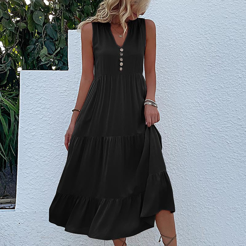 FJØRNA summer casual wedding dress with floral print, sleeveless design, and flowing fabric perfect for warm-weather occasions.