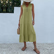 Light beige casual wedding dress by FJØRNA with flowy fabric, sleeveless design, and elegant summer style.