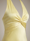 Elegant women's maxi dress by FJØRNA featuring a fitted design and halter neck, perfect for formal summer occasions.
