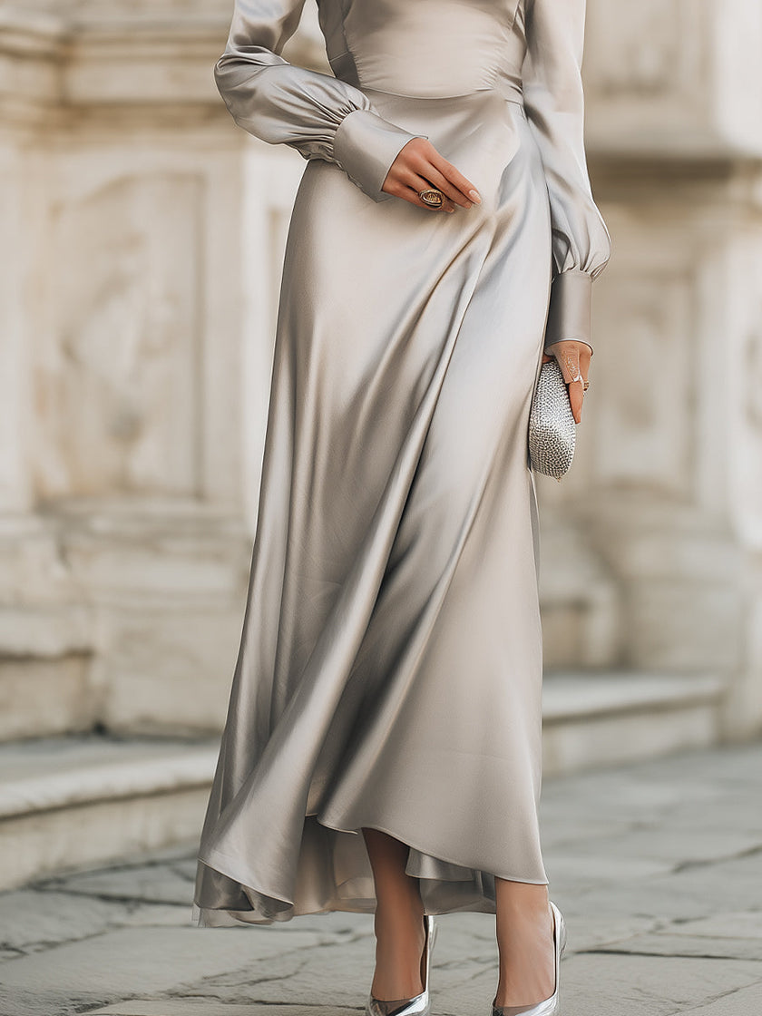 FJØRNA draped cowl neck long evening gown with sleeves, elegant maxi dress shown in black fabric with a flowing silhouette.