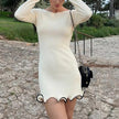 FJØRNA white mini dress, hemline detail, sleeveless design, perfect for summer or casual outings, displayed on a hanger.