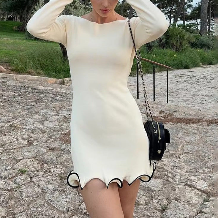 FJØRNA white mini dress, hemline detail, sleeveless design, perfect for summer or casual outings, displayed on a hanger.