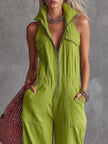 Bright green cotton linen jumpsuit by FJØRNA with a front zipper, sleeveless design, and relaxed fit on model.