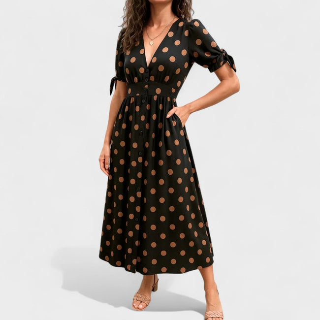FJØRNA summer mini dress for women featuring a polka dot pattern and V-neck design, perfect for warm weather wear.