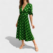 FJØRNA women's summer mini dress with polka dots and V-neck, lightweight and stylish for warm weather.
