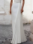 Elegant satin pleated halter-neck evening gown by FJØRNA, showcasing a flowing design with a sophisticated silhouette.