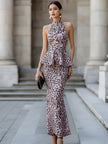 FJØRNA halter peplum midi dress for women with sculpted waist and elegant silhouette, displayed on a model.