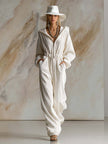 White corduroy hooded zip-front jumpsuit by FJØRNA featuring long sleeves and a stylish, casual design.