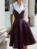 White button-up shirt dress by FJØRNA with wine-red leather suspender overlay, structured and stylish for a modern look.