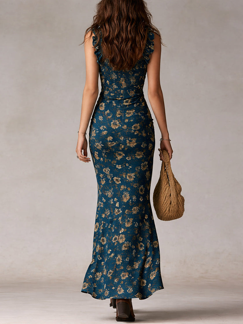 FJØRNA ruffle maxi dress, casual style with flowing fabric and ruffled details, shown on a model in a light, breezy outdoor setting.