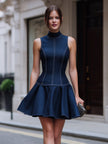 FJØRNA sleeveless high neck fit and flare mini dress displayed on a model, featuring a stylish silhouette and elegant design.