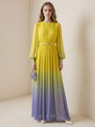 FJØRNA high waisted maxi dress with long sleeves, belt, contrast color gradient, pleated design, split joint, and round neckline.