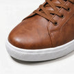 FJØRNA men's leather lace-up low top sneakers with sleek design, black leather upper, and white rubber sole.