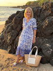 FJØRNA women's floral summer midi dress with flowy fabric, perfect for warm-weather casual wear, shown hanging on a hanger.