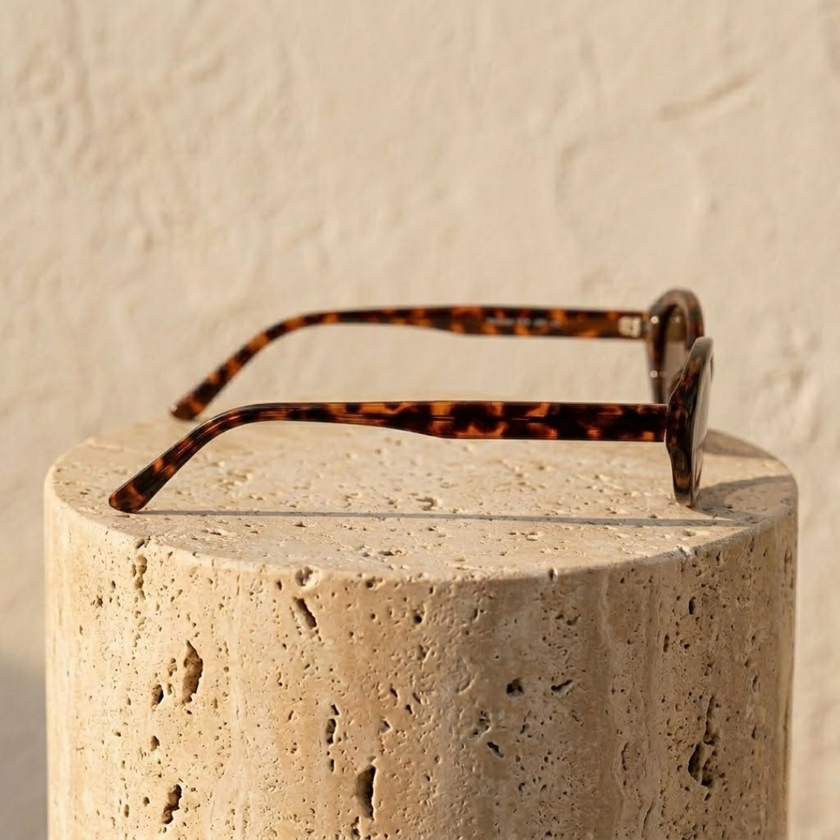 Unisex retro oval sunglasses by FJØRNA with dark tinted lenses and black frame, stylish accessories for women.