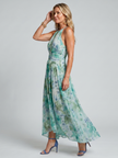 FJØRNA women's floral summer midi dress with halter neck, sleeveless design, and pleated details, perfect for warm weather.
