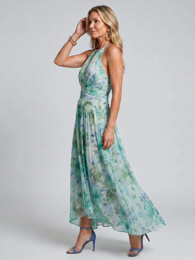 FJØRNA women's floral summer midi dress with halter neck, sleeveless design, and pleated details, perfect for warm weather.