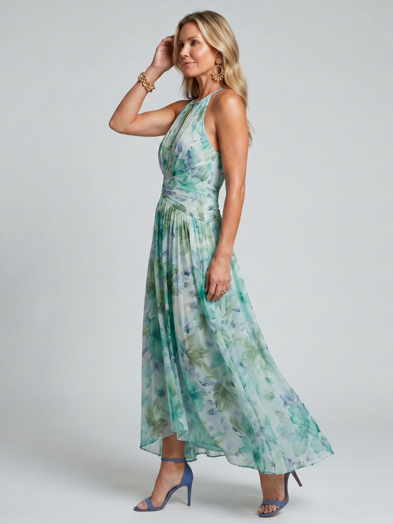 FJØRNA women's floral summer midi dress with halter neck, sleeveless design, and pleated details, perfect for warm weather.
