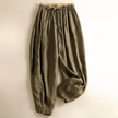 FJØRNA women's linen tapered trousers, lightweight and breathable, shown on a model with a relaxed fit and natural waist.