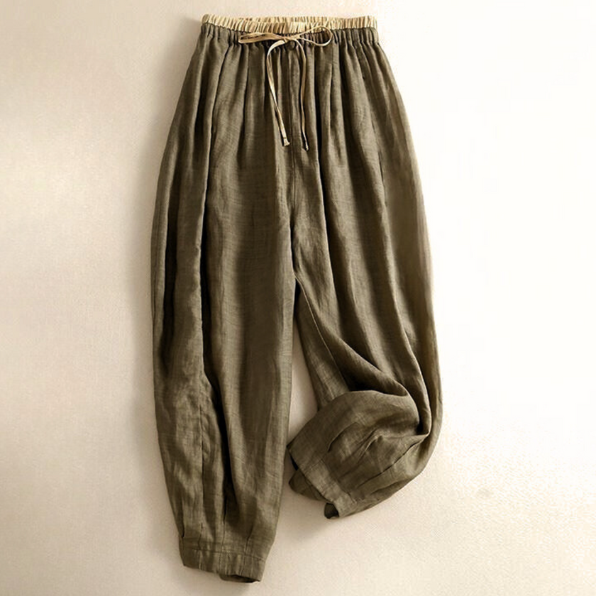 FJØRNA women's linen tapered trousers, lightweight and breathable, shown on a model with a relaxed fit and natural waist.