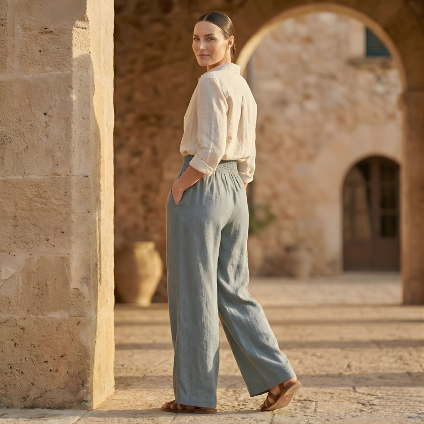 FJØRNA women's high waist wide leg elastic trousers showing the relaxed fit and soft fabric in a neutral color.