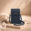 FJØRNA women’s crossbody bag in black leather with adjustable strap and minimalist design, suitable for everyday use.