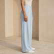 Women’s FJØRNA criss cross waist wide leg trousers, stylish pants with a relaxed fit and high waist, displayed on a model.