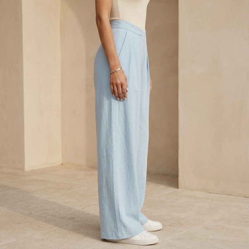 Women’s FJØRNA criss cross waist wide leg trousers, stylish pants with a relaxed fit and high waist, displayed on a model.