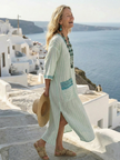FJØRNA women's summer midi dress with striped pattern, short sleeves, wrap design, and flowy fabric.