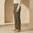 Men's linen trousers by FJØRNA with drawstring waist and pleated design, featuring a relaxed fit and lightweight fabric.