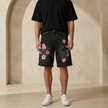 FJØRNA men's floral denim shorts with distressed details, casual fit, and vibrant floral pattern for summer style.