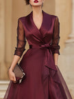 FJØRNA elegant wrap midi dress for women with sheer sleeves, flowing fabric, and sophisticated style.