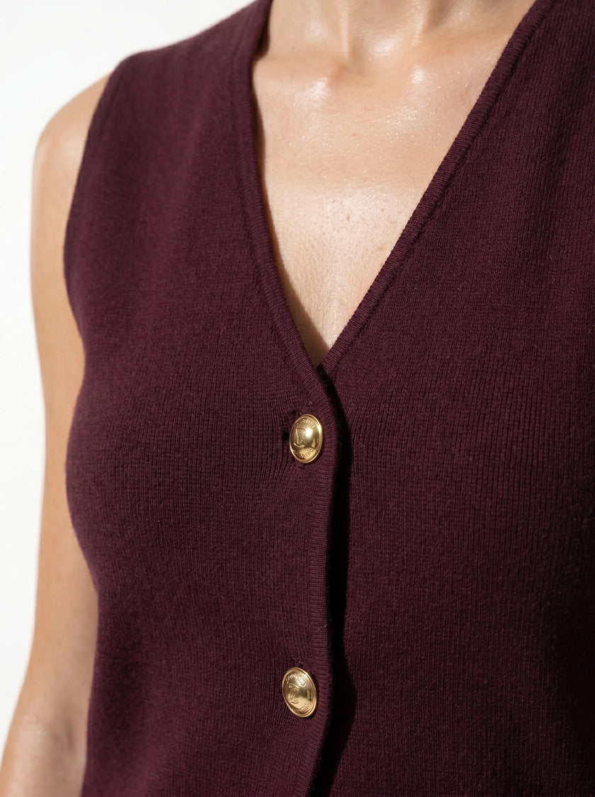 Close-up of FJØRNA women's sleeveless structured waistcoat with tailored layering, showing detailed stitching and fabric texture.