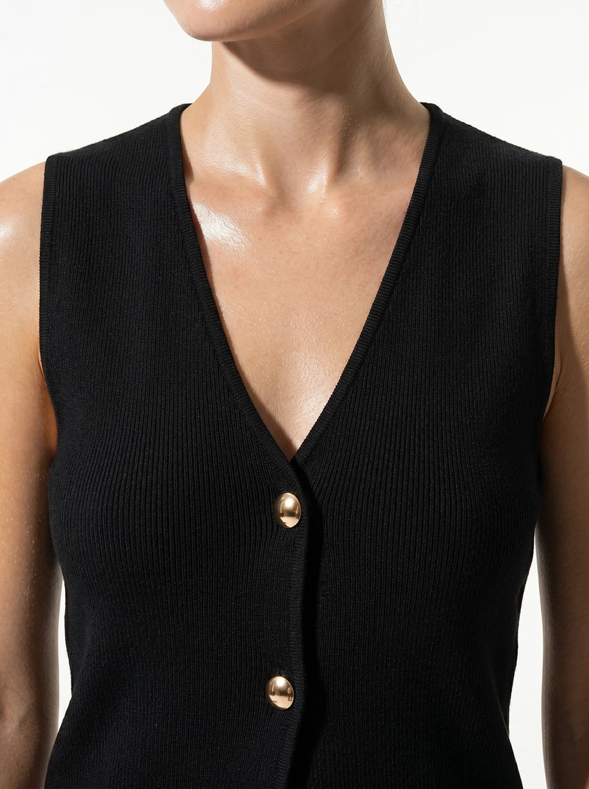 Close-up of FJØRNA women's sleeveless structured waistcoat, tailored layering piece with a fitted, professional look.