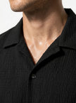 Close-up of FJØRNA men's short sleeve button-up shirt, showcasing the classic casual design and fabric details.